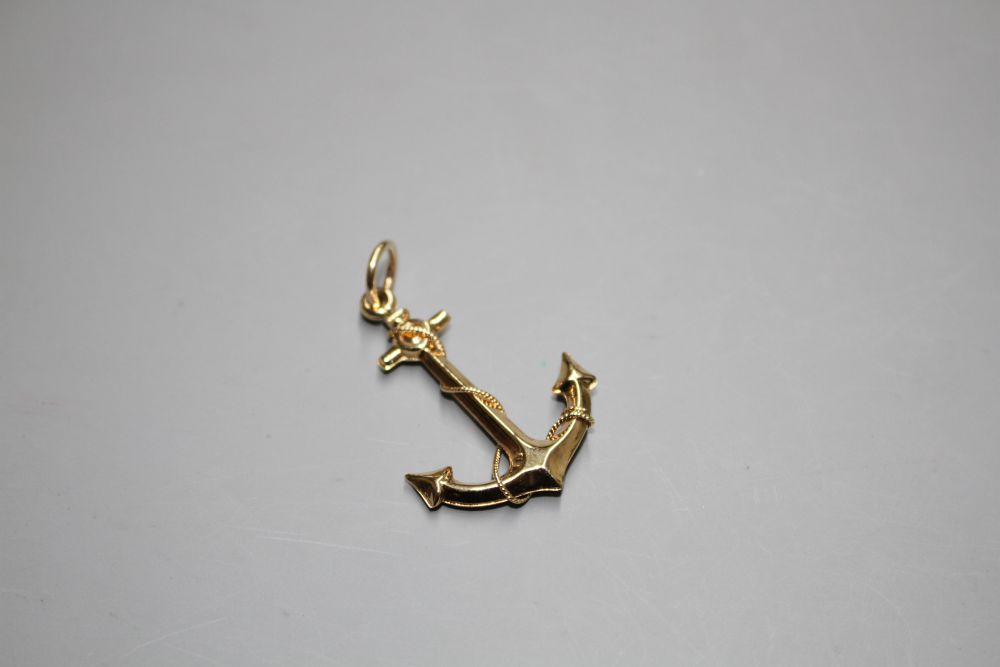 A yellow metal pendant, modelled as an anchor,